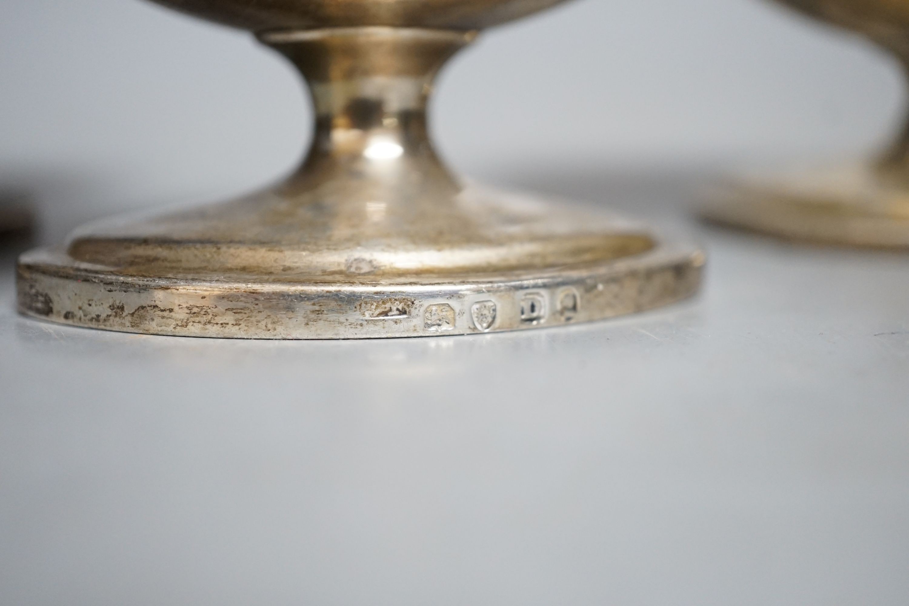 A set of four George III silver boat shaped pedestal salts, London, 1799, maker's mark rubbed, length 10cm, 345 grams.